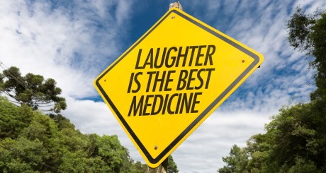 a road sign that says laughter is the best medicine