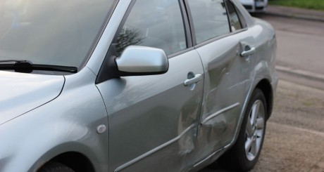 car with dents on the side