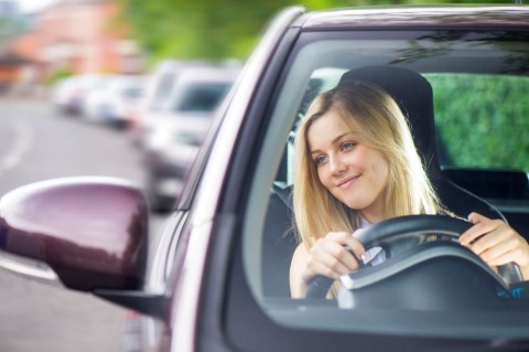 woman checking car side mirrors