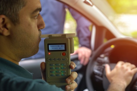 man taking breathalyzer test